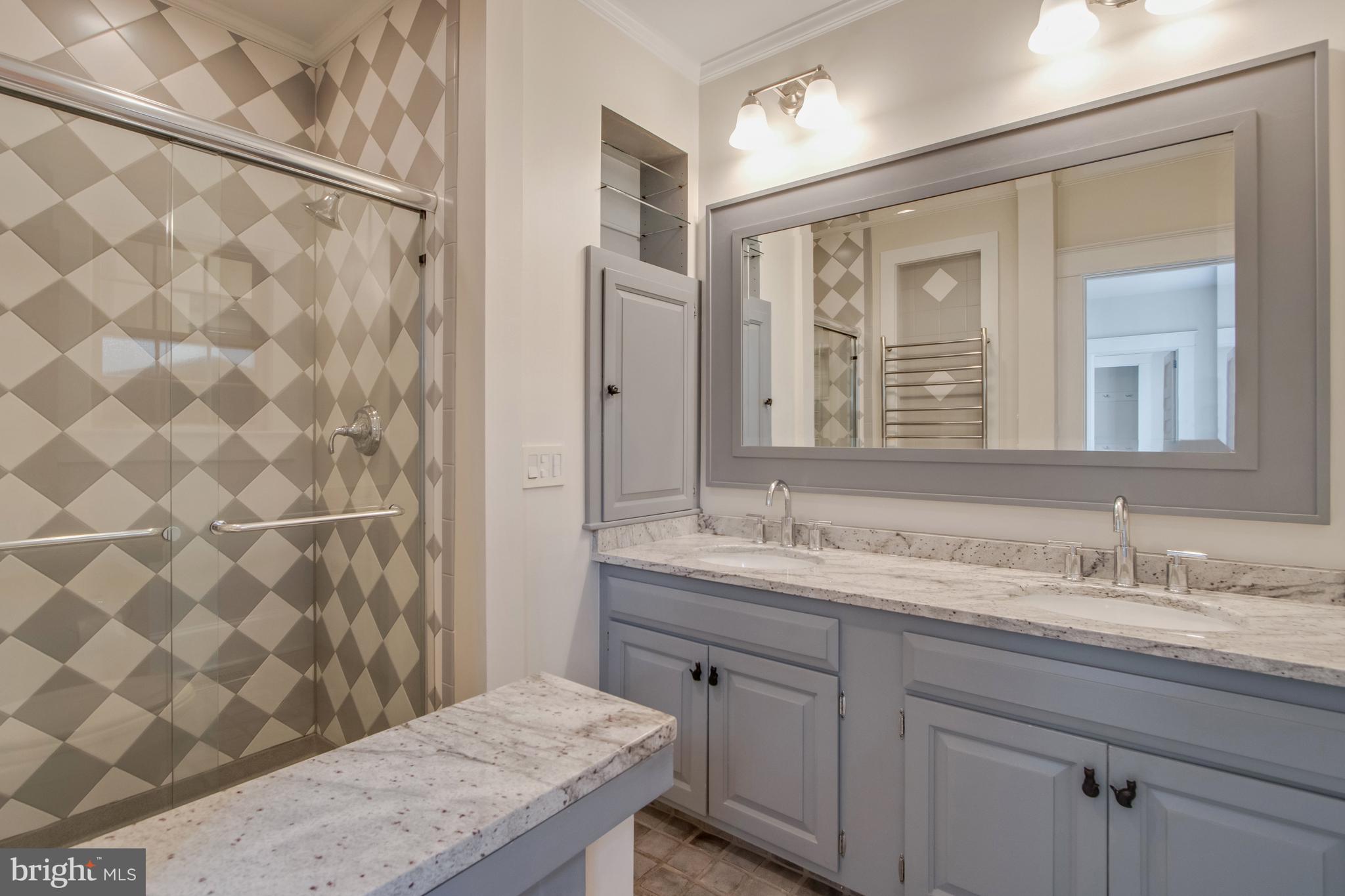 901 Savannah Road Lewes, DE 19958 - Photo 22 of 83 a bathroom with a granite countertop sink a mirror and a shower