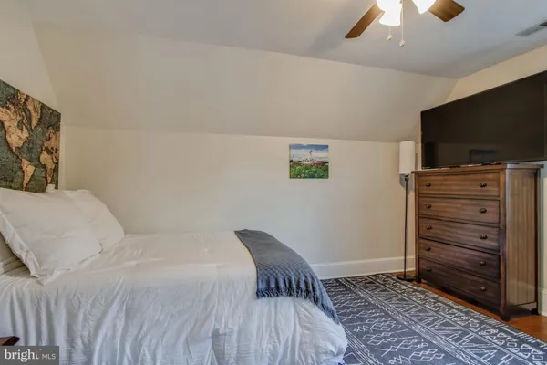 a living room with furniture and wall paintings