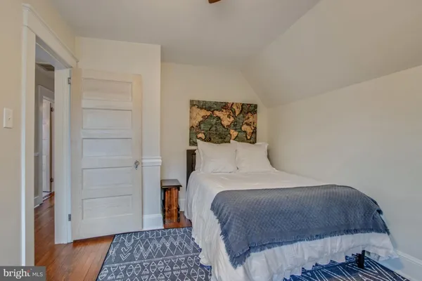 a bedroom with a large bed and a chandelier