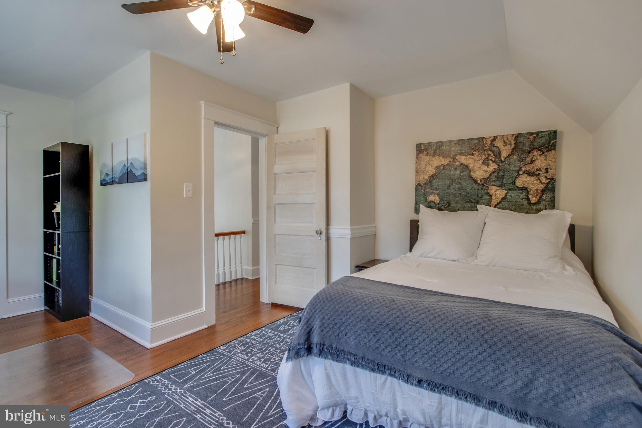 901 Savannah Road Lewes, DE 19958 - Photo 25 of 83 a bedroom with a large bed and a chandelier