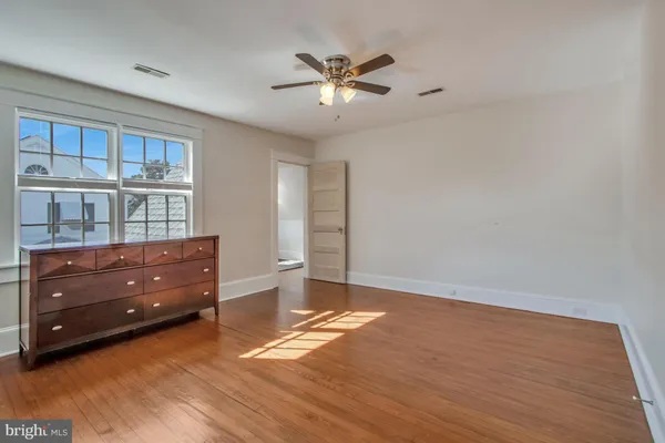a bedroom with a bed a table and chair