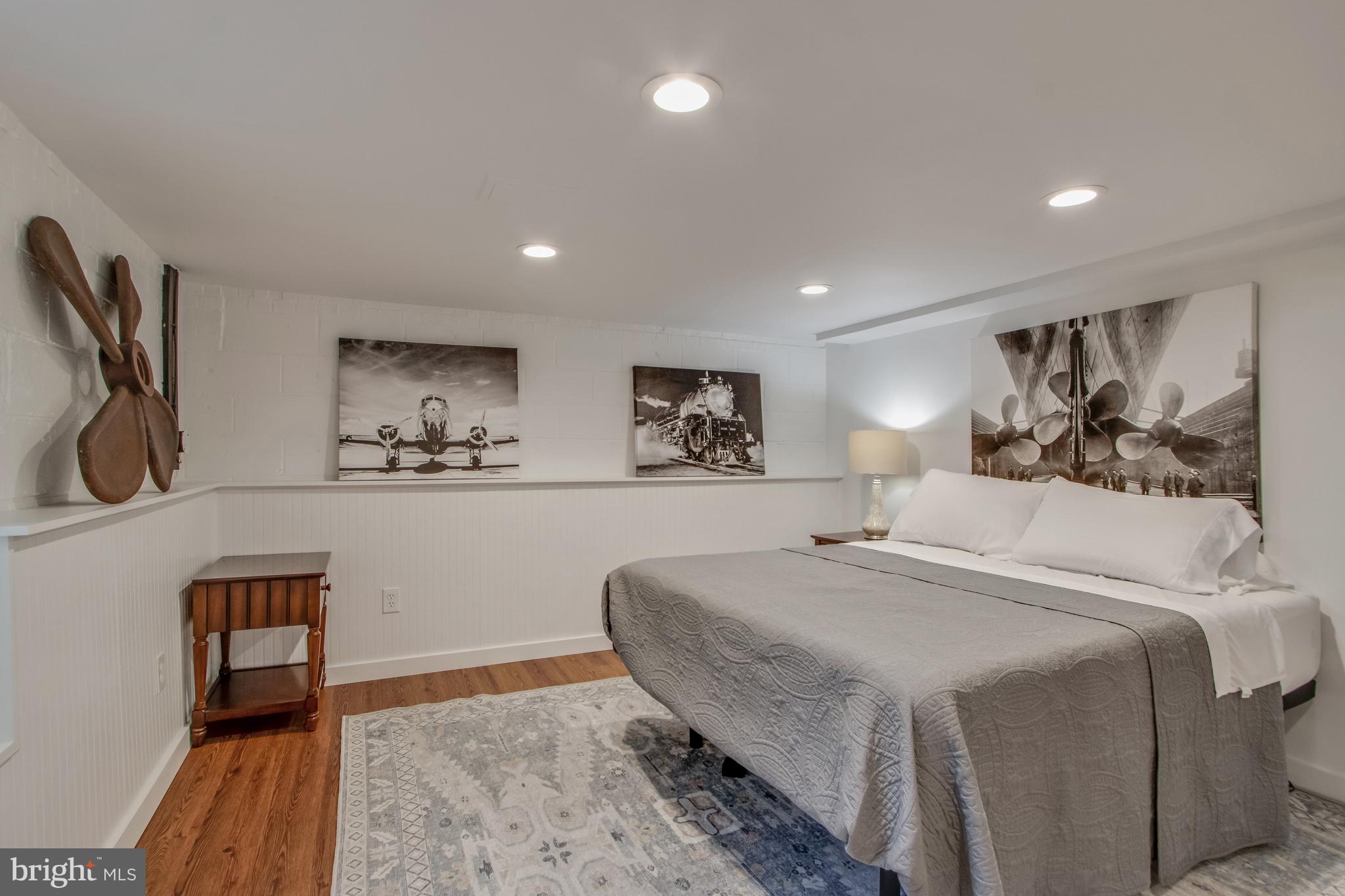 901 Savannah Road Lewes, DE 19958 - Photo 34 of 83 a bedroom with a large bed and a chandelier