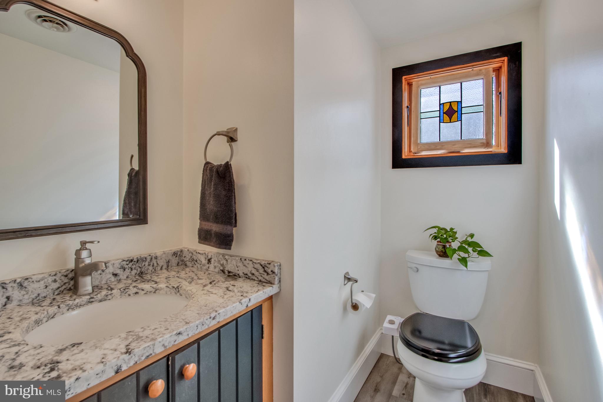 901 Savannah Road Lewes, DE 19958 - Photo 49 of 83 a bathroom with a granite countertop sink and a mirror