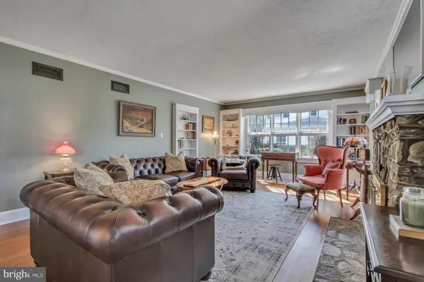 a living room with furniture a fireplace and a window