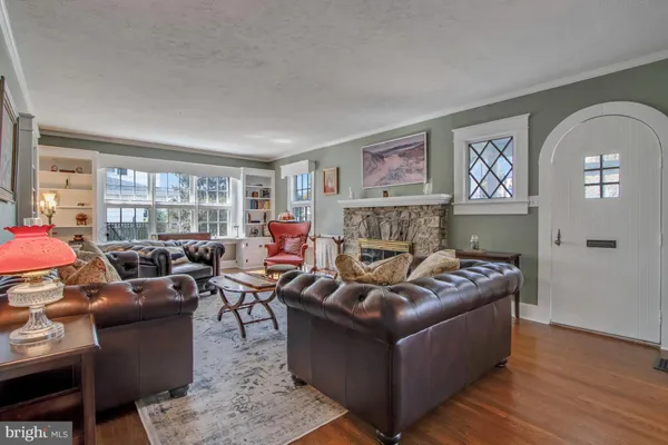 a view of a dining room with furniture a chandelier and a window