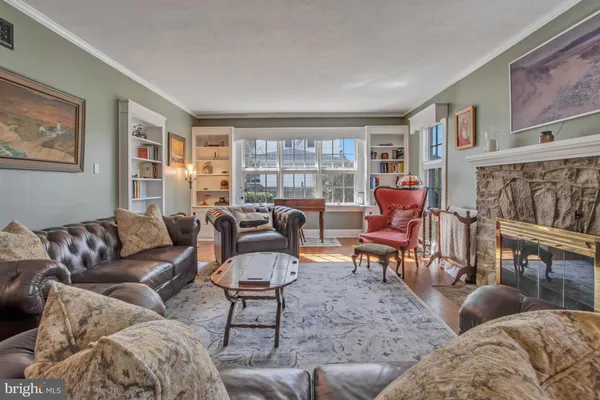 a view of a dining room with furniture a rug and wooden floor