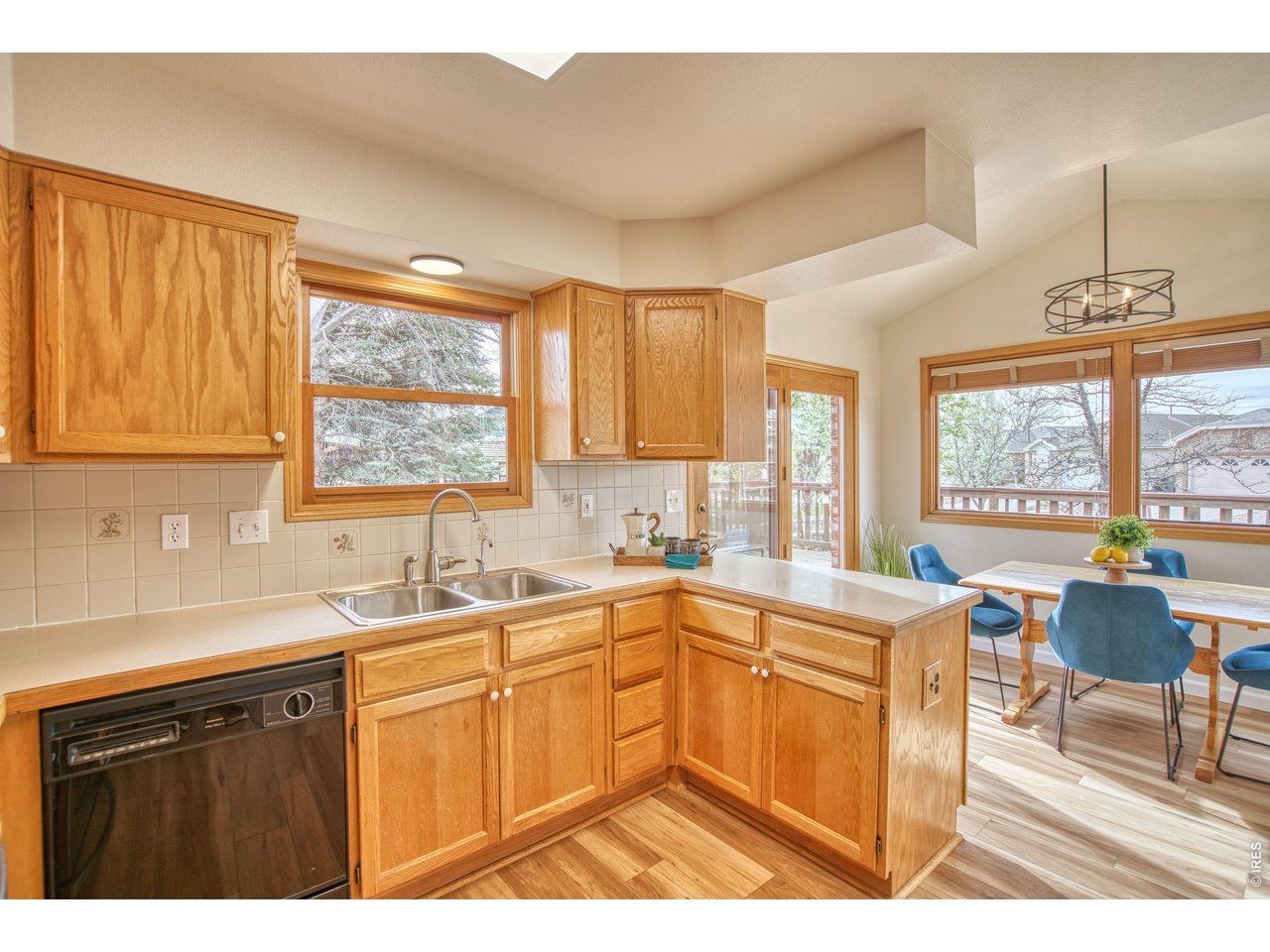 824 Wade Road Longmont, CO 80503 - Photo 12 of 34 a kitchen with a sink a counter top space cabinets and stainless steel appliances