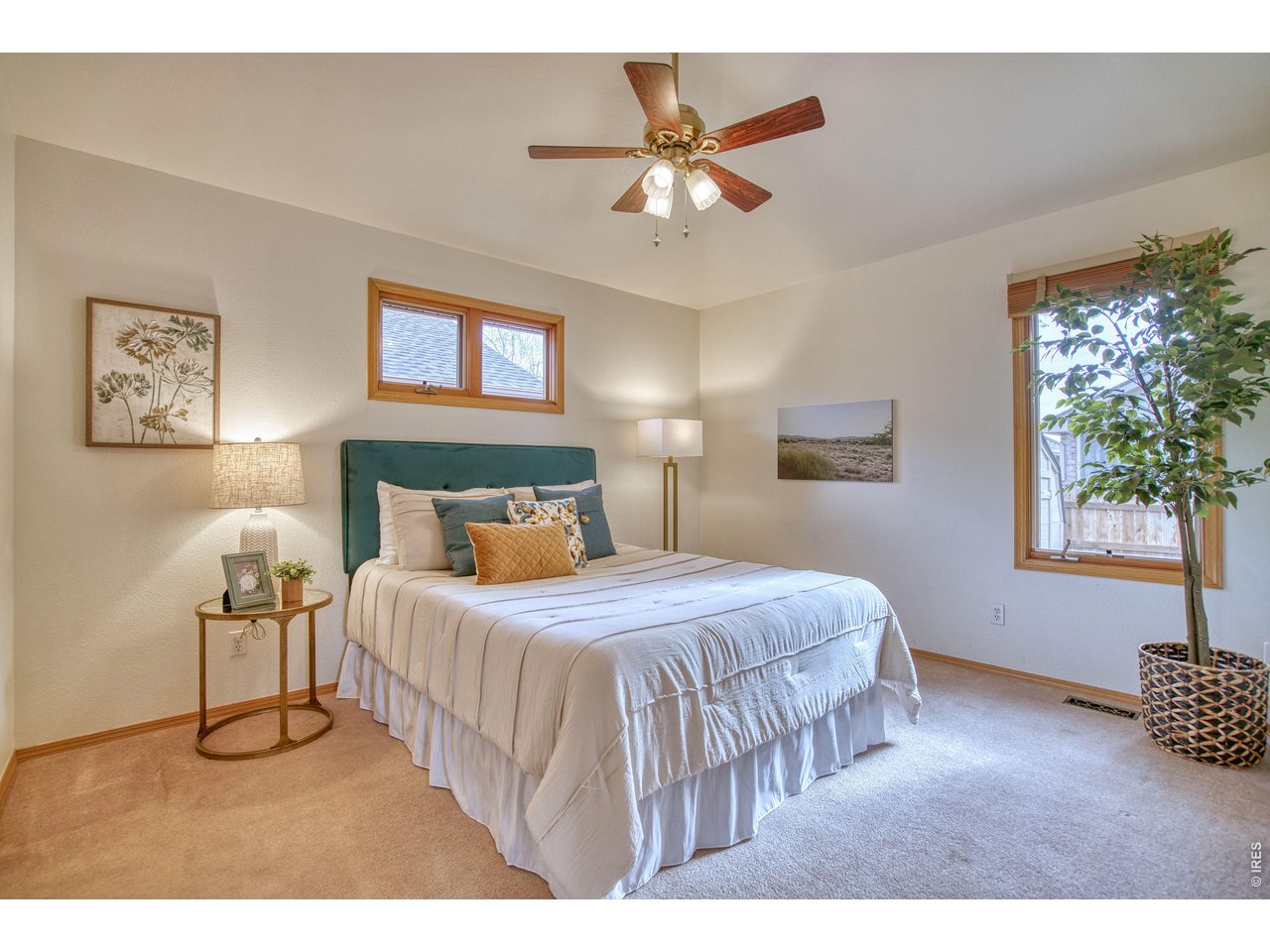 824 Wade Road Longmont, CO 80503 - Photo 17 of 34 a bedroom with a bed mirror and a window