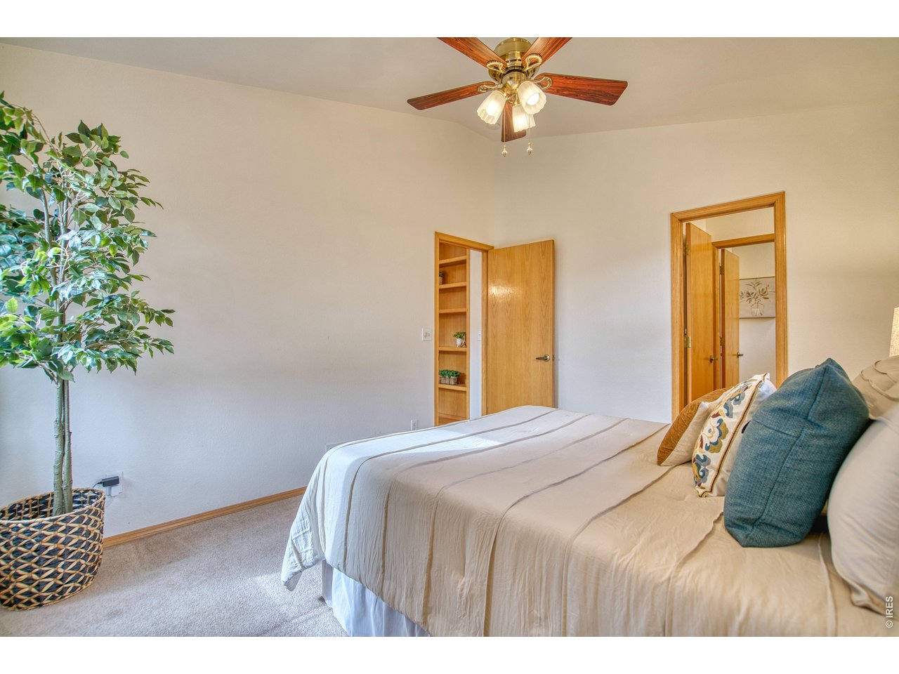 824 Wade Road Longmont, CO 80503 - Photo 18 of 34 a bedroom with a bed and a chandelier