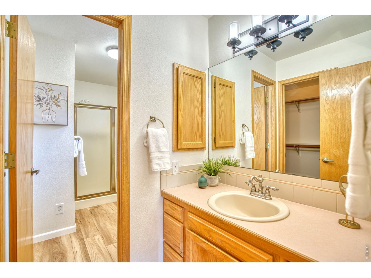 824 Wade Road Longmont, CO 80503 - Photo 19 of 34 a bathroom with a sink and a mirror