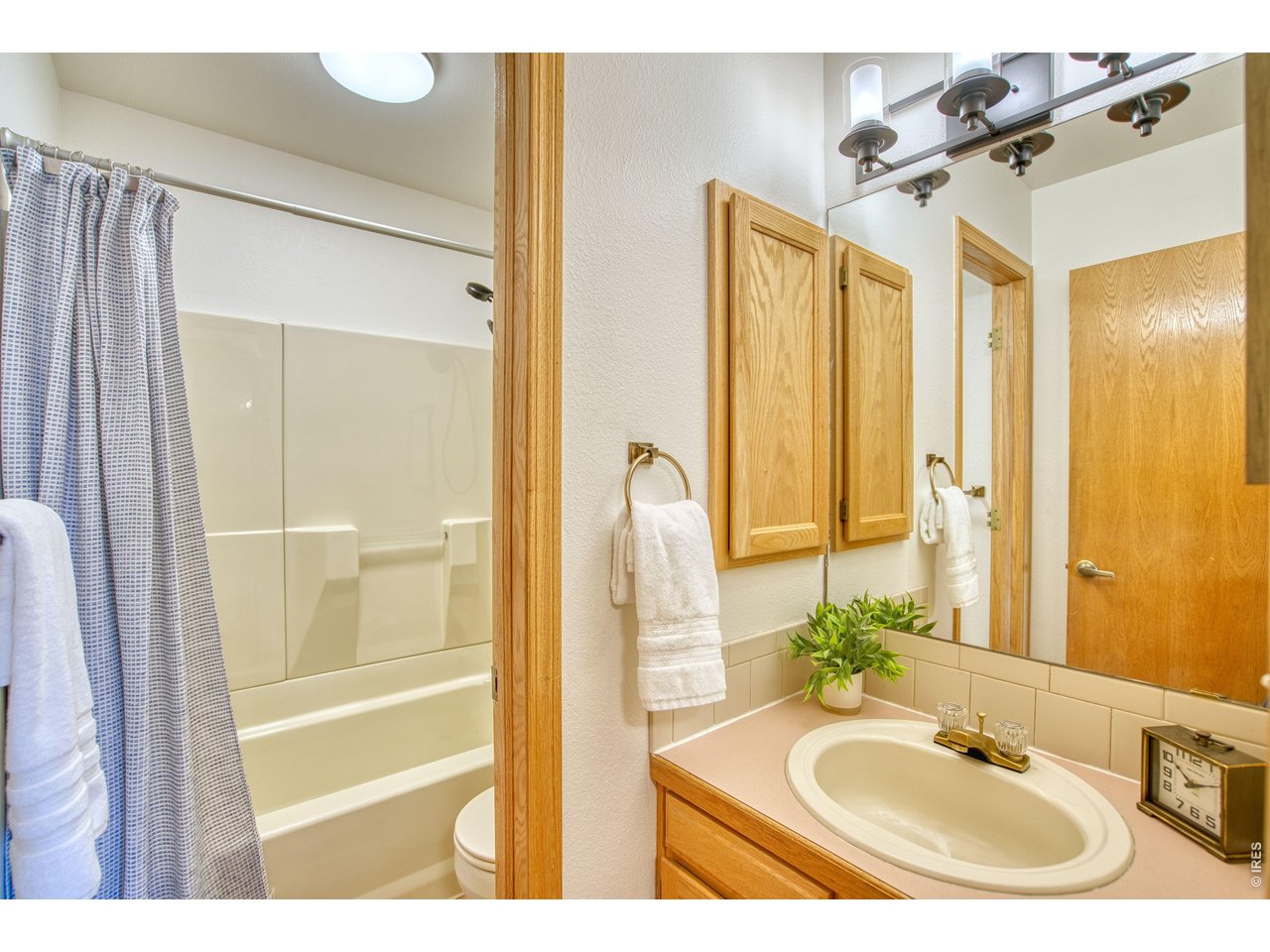 824 Wade Road Longmont, CO 80503 - Photo 20 of 34 a bathroom with a sink and a mirror