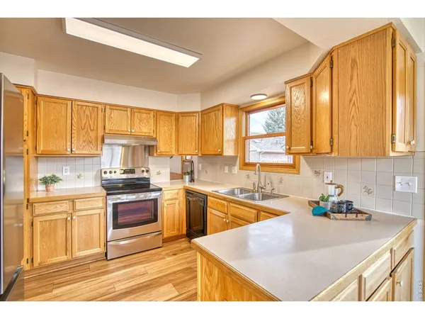 a kitchen with stainless steel appliances granite countertop a sink and cabinets