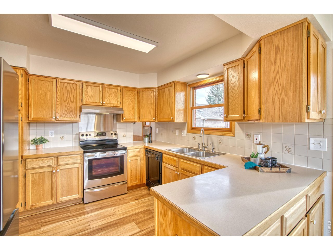 824 Wade Road Longmont, CO 80503 - Photo 10 of 34 a kitchen with stainless steel appliances granite countertop a sink and cabinets