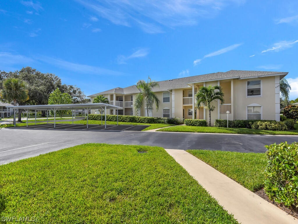 654 Squire Circle, Unit 103 Naples, FL 34104 - Photo 1 of 23 a view of a house with a swimming pool