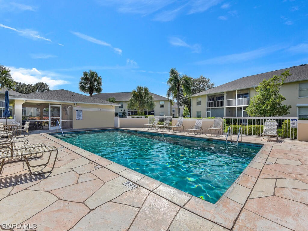 654 Squire Circle, Unit 103 Naples, FL 34104 - Photo 23 of 23 a view of a patio with a table and chairs