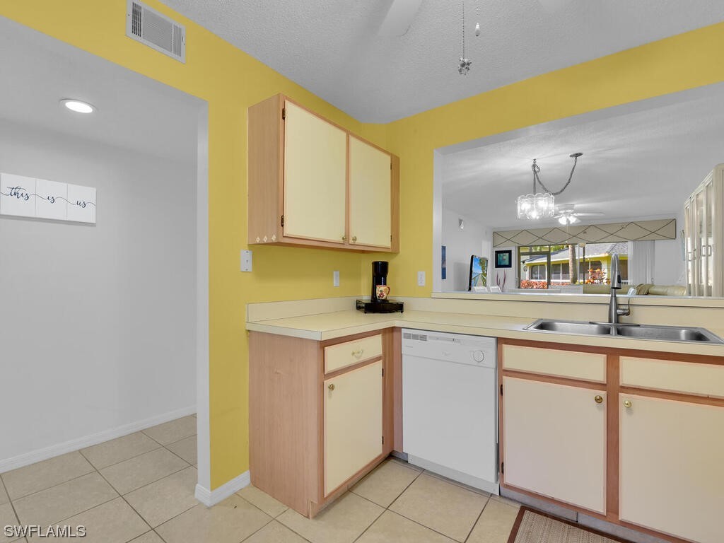 654 Squire Circle, Unit 103 Naples, FL 34104 - Photo 6 of 23 a kitchen with a sink cabinets and window