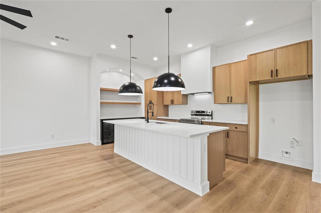 2820 Barnes Bridge Road Dallas, TX 75228 - Photo 11 of 29 a kitchen with kitchen island a sink stainless steel appliances and cabinets