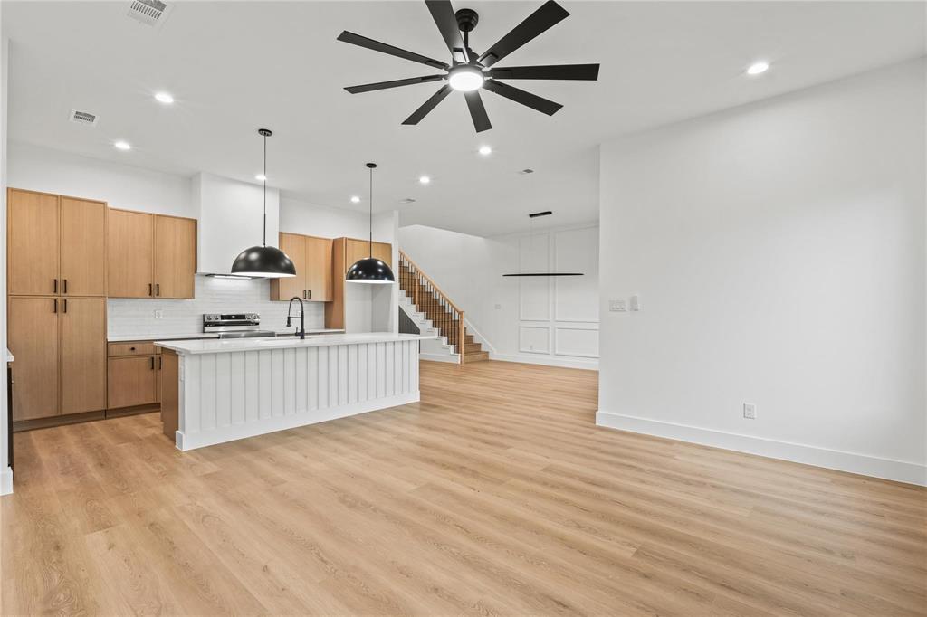 2820 Barnes Bridge Road Dallas, TX 75228 - Photo 12 of 29 a living room with kitchen island furniture and a wooden floor