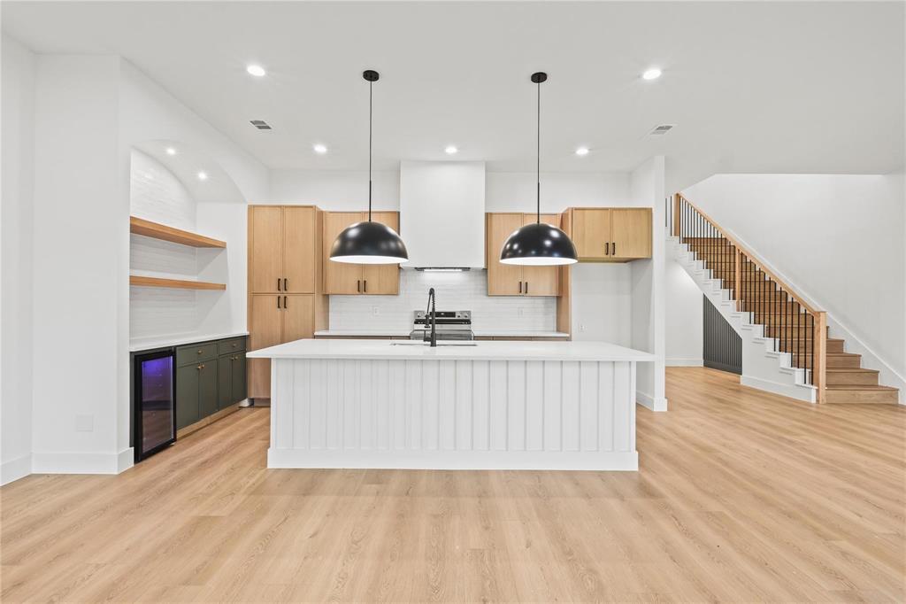 2820 Barnes Bridge Road Dallas, TX 75228 - Photo 13 of 29 a view of kitchen with kitchen island stainless steel appliances sink stove and wooden floor