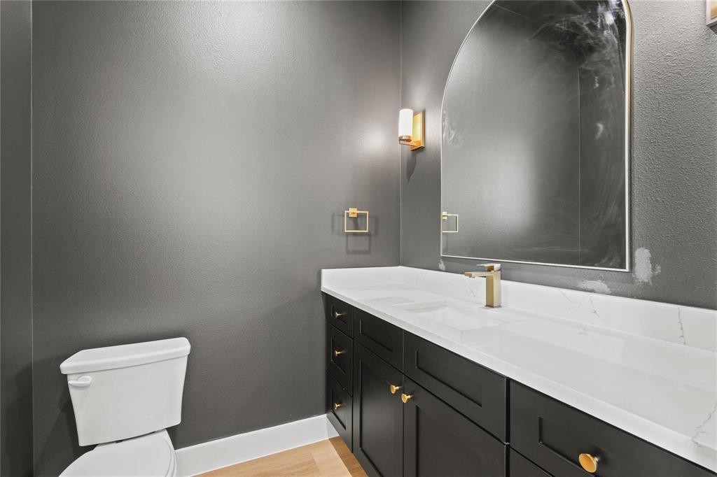 2820 Barnes Bridge Road Dallas, TX 75228 - Photo 17 of 29 a bathroom with a toilet sink and mirror