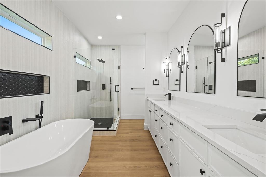 2820 Barnes Bridge Road Dallas, TX 75228 - Photo 20 of 29 a spacious bathroom with a double vanity sink a mirror and a bathtub