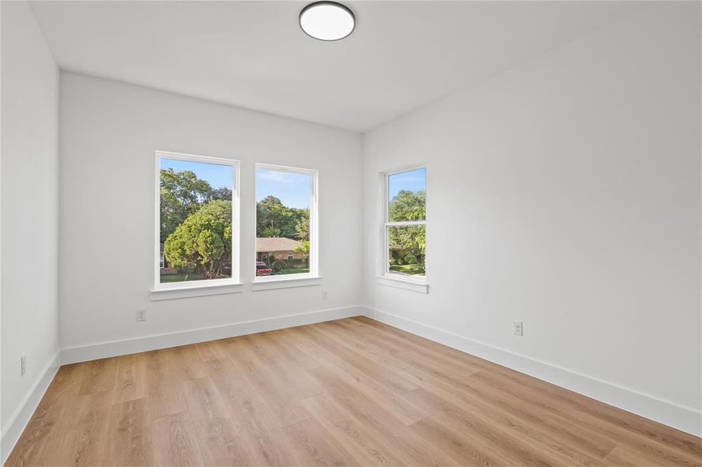 2820 Barnes Bridge Road Dallas, TX 75228 - Photo 22 of 29 an empty room with wooden floor and windows
