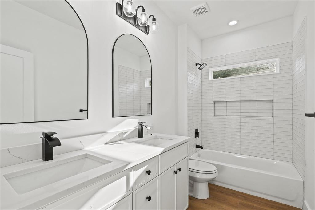 2820 Barnes Bridge Road Dallas, TX 75228 - Photo 24 of 29 a bathroom with a granite countertop sink a toilet and a mirror