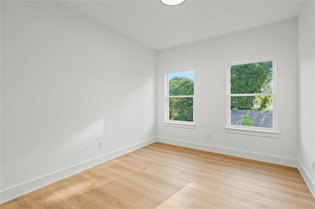 2820 Barnes Bridge Road Dallas, TX 75228 - Photo 25 of 29 an empty room with wooden floor and windows
