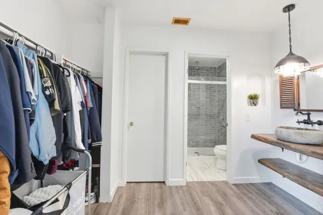 a bathroom with a sink a mirror and shower
