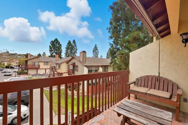 a view of a roof deck with wooden fence