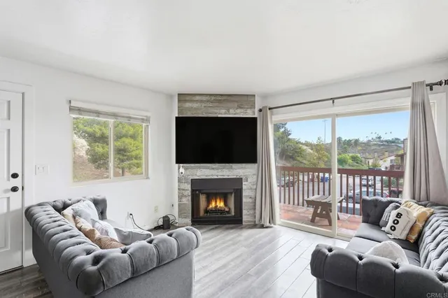 a living room with furniture fireplace and a flat screen tv