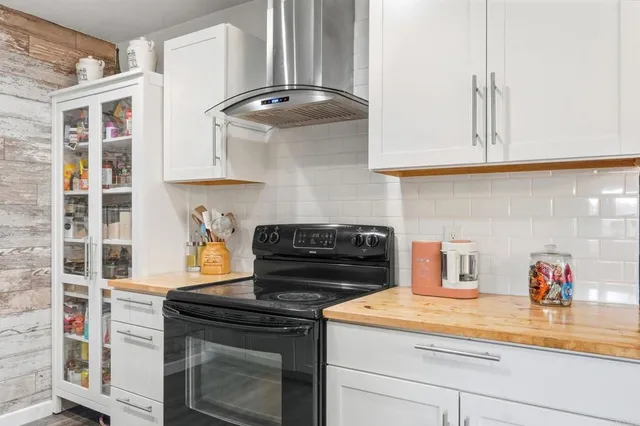 a kitchen with stainless steel appliances granite countertop a stove and a cabinets