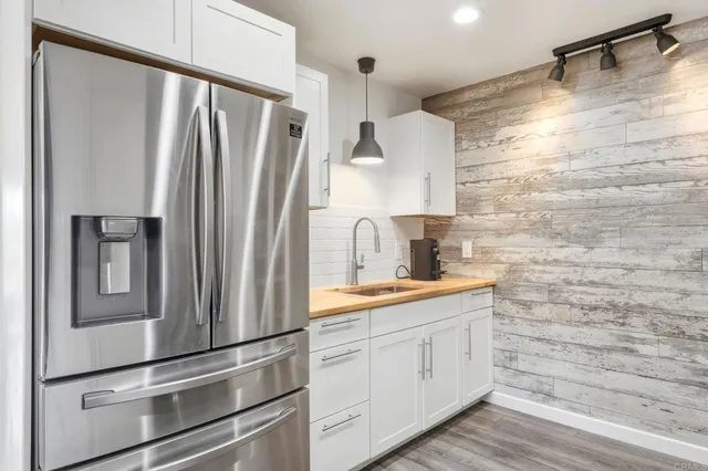 a kitchen with stainless steel appliances a refrigerator and a sink