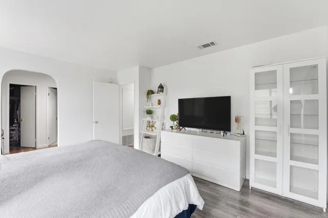 a bedroom with a bed and a flat screen tv