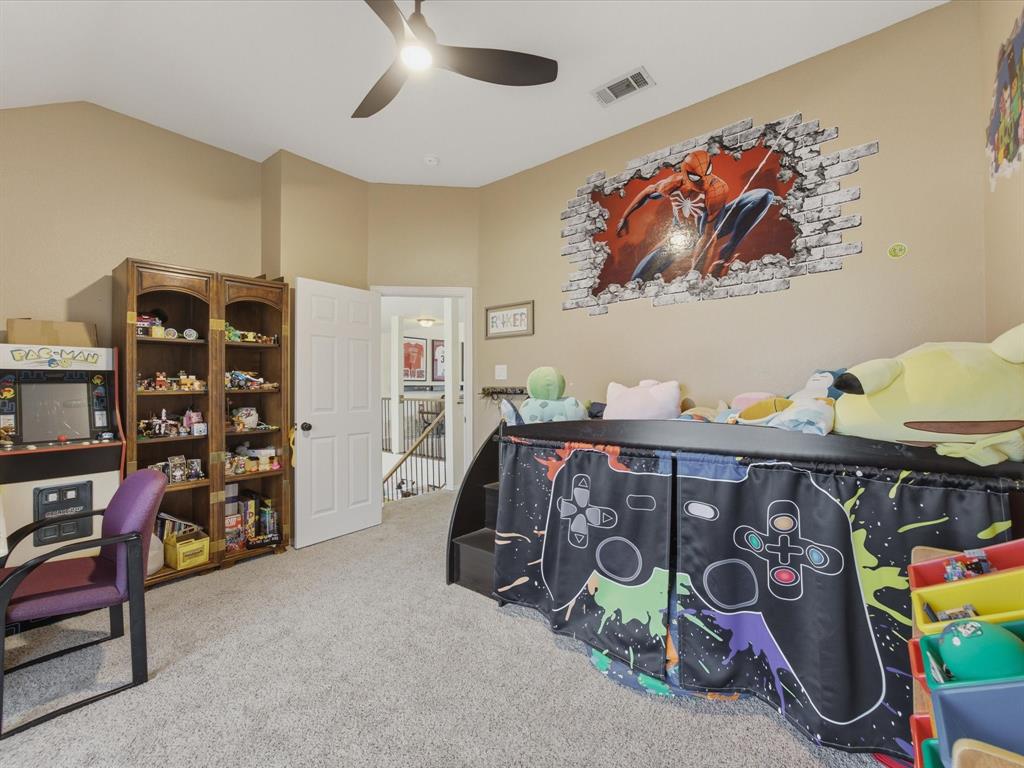 4008 Falcon Ridge Drive Haltom City, TX 76137 - Photo 30 of 40 Carpeted room featuring a ceiling fan with integrated lighting, and a window with blinds