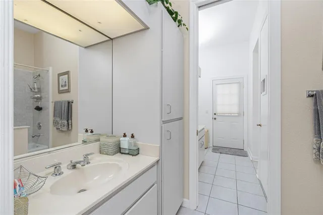 a living room with furniture kitchen view and a chandelier