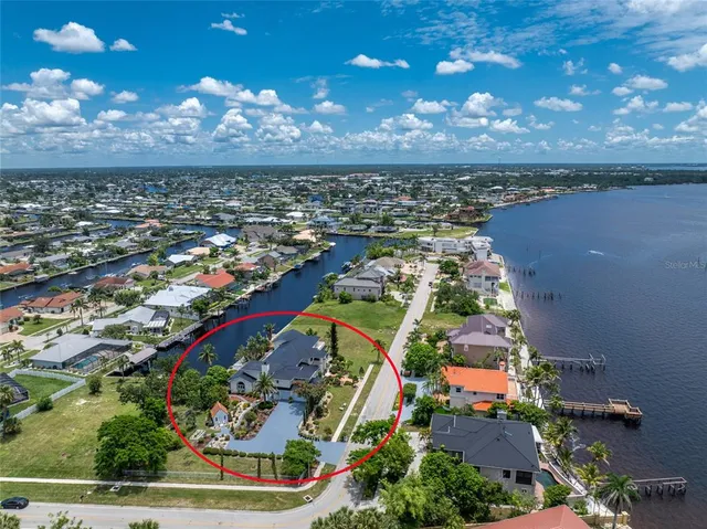a view of a dining room with furniture a rug and wooden floor