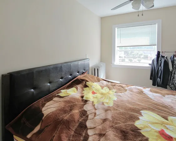 a bed sitting in a bedroom next to a window