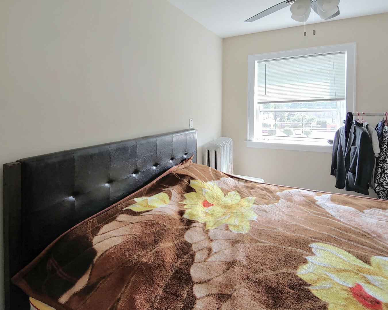 4815 North Springfield Avenue, Unit 3E Chicago, IL 60625 - Photo 3 of 8 a bed sitting in a bedroom next to a window