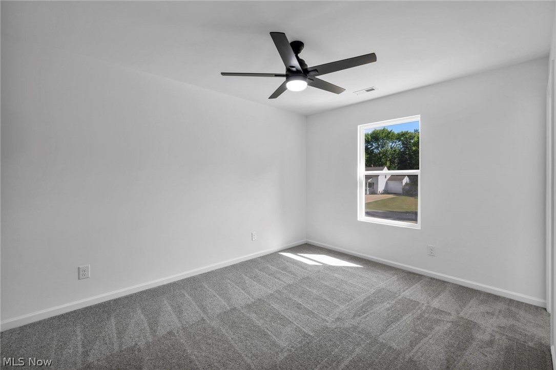 7602 Hickory Road Bedford, OH 44146 - Photo 16 of 36 Empty room featuring a ceiling fan and carpet flooring