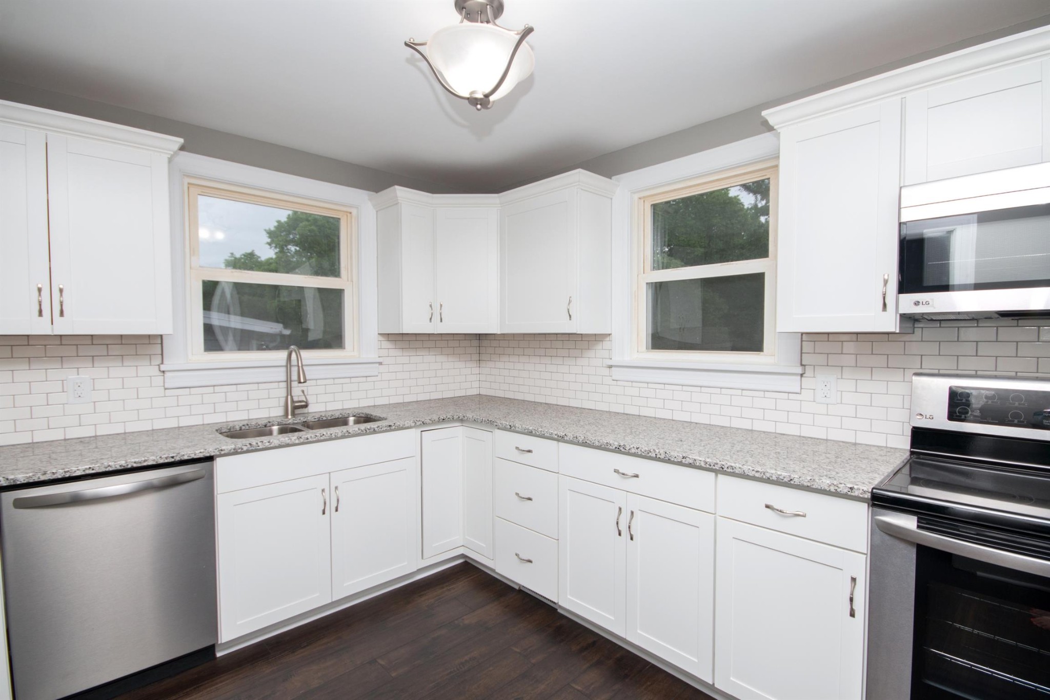 212 Neelys Bend Road Madison, TN 37115 - Photo 5 of 14 a kitchen with a sink stove and microwave