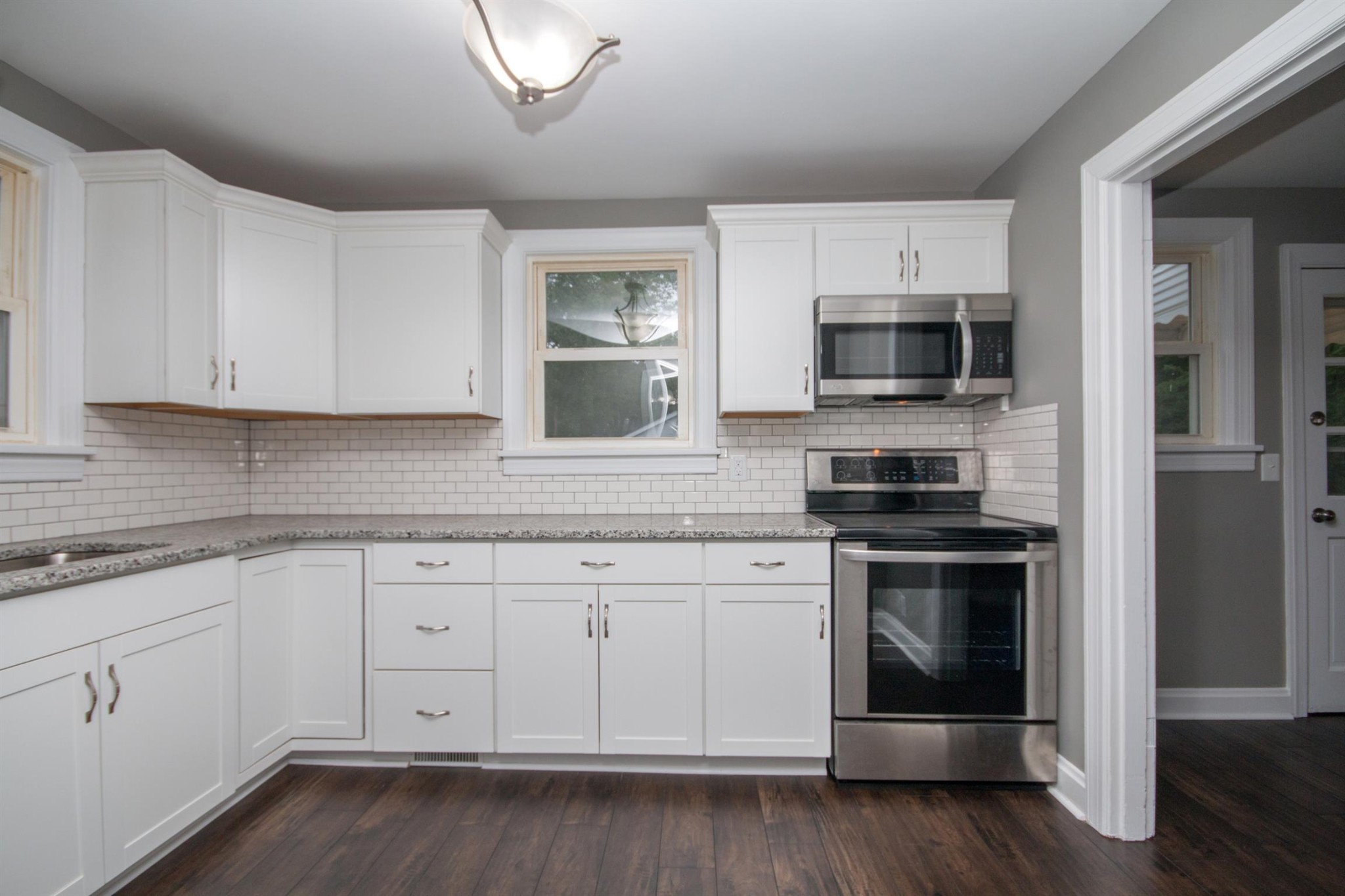212 Neelys Bend Road Madison, TN 37115 - Photo 6 of 14 a kitchen with white cabinets stainless steel appliances and sink