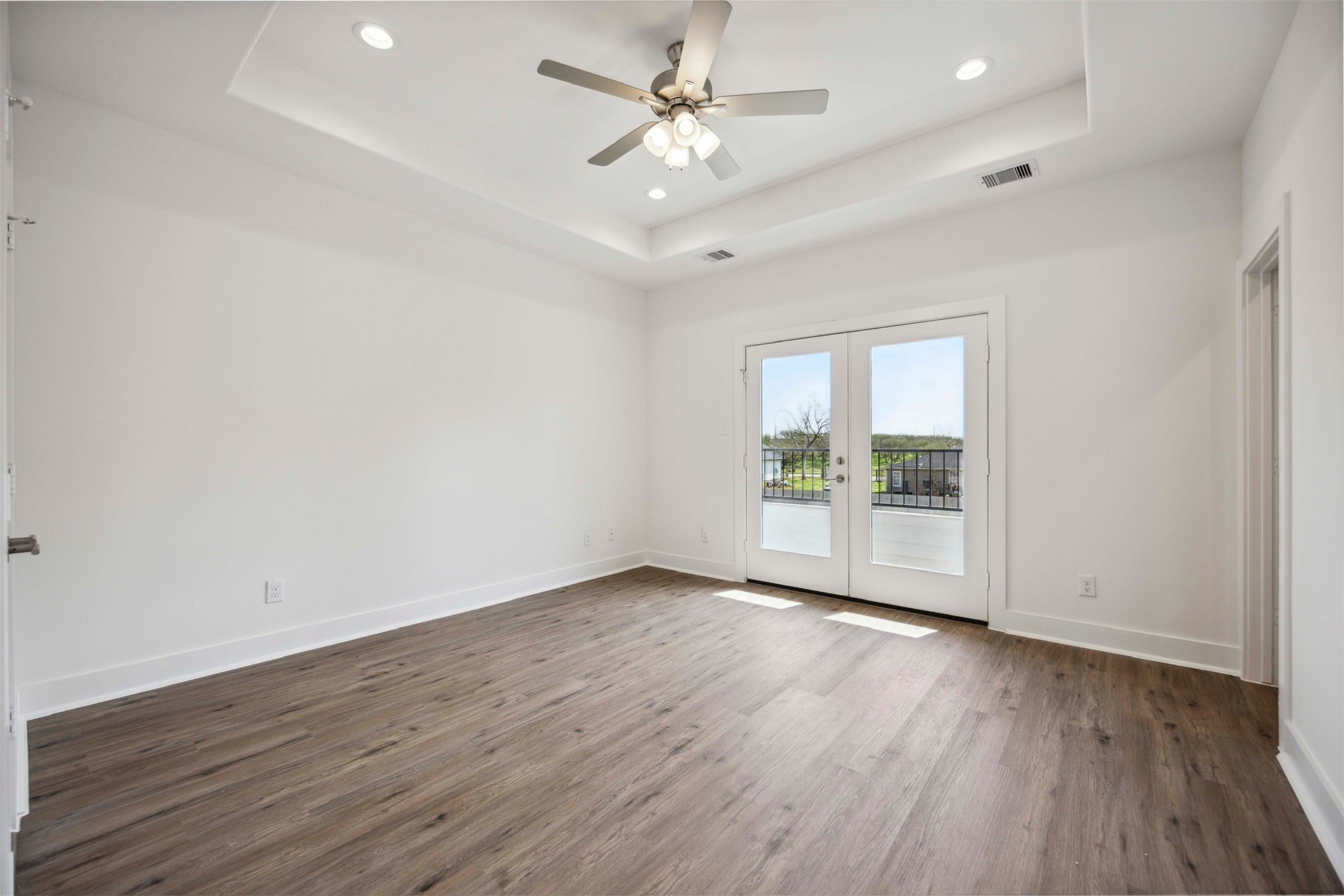 3504 Caplin Street, Unit B Houston, TX 77026 - Photo 12 of 26 an empty room with wooden floor and a ceiling fan