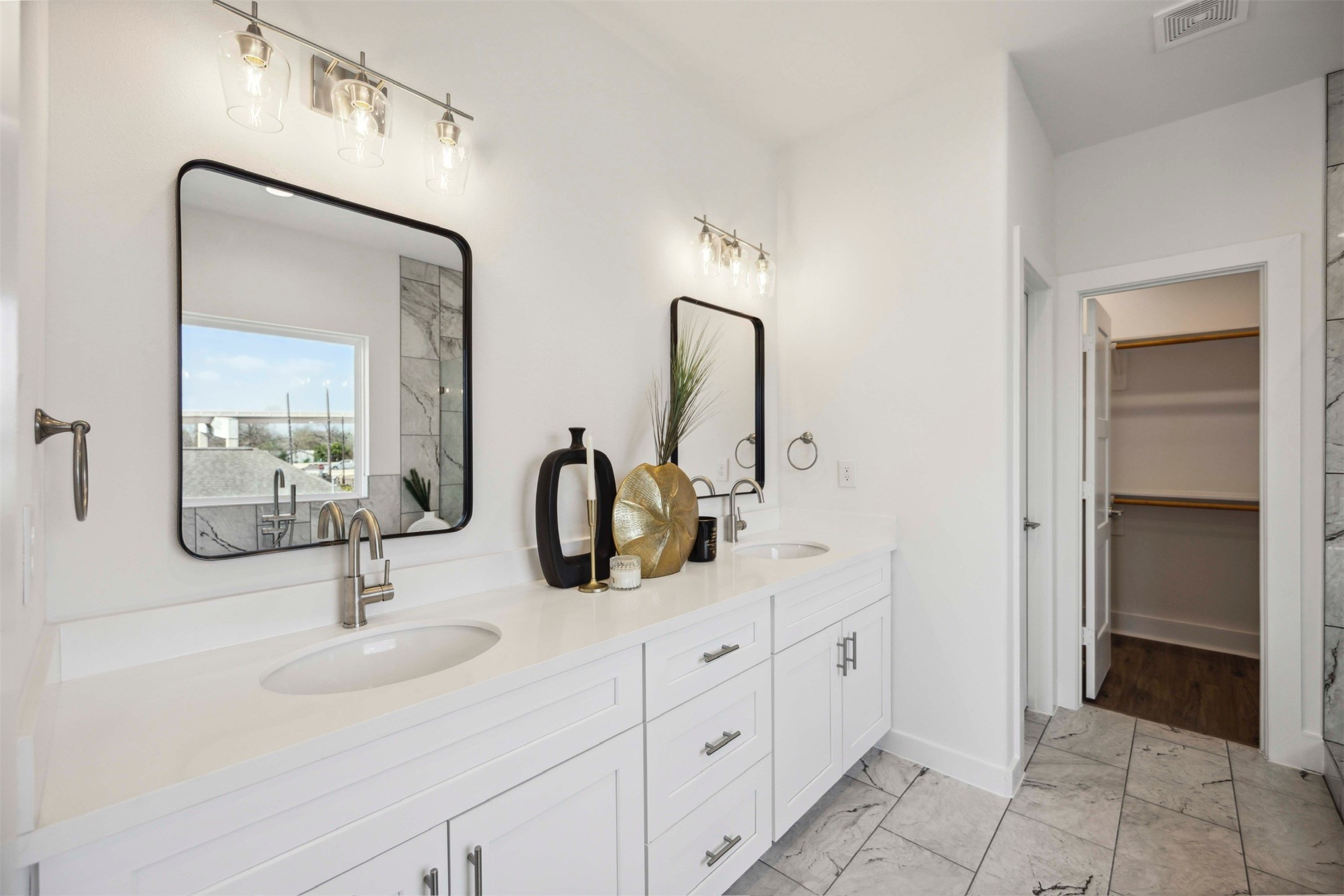 3504 Caplin Street, Unit B Houston, TX 77026 - Photo 15 of 26 a bathroom with double vanity sinks and a mirror