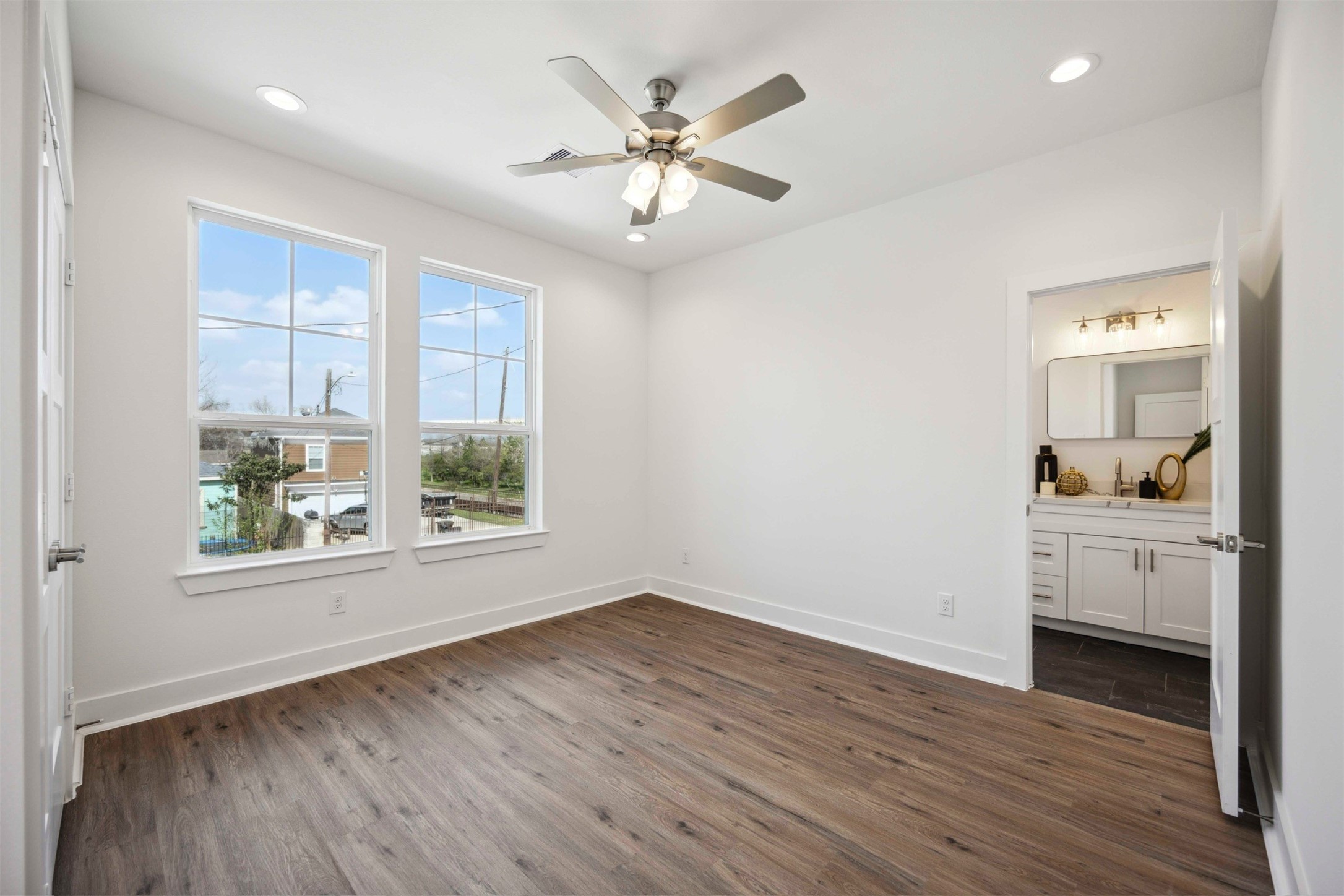 3504 Caplin Street, Unit B Houston, TX 77026 - Photo 20 of 26 a view of work space with wooden floor and a ceiling fan