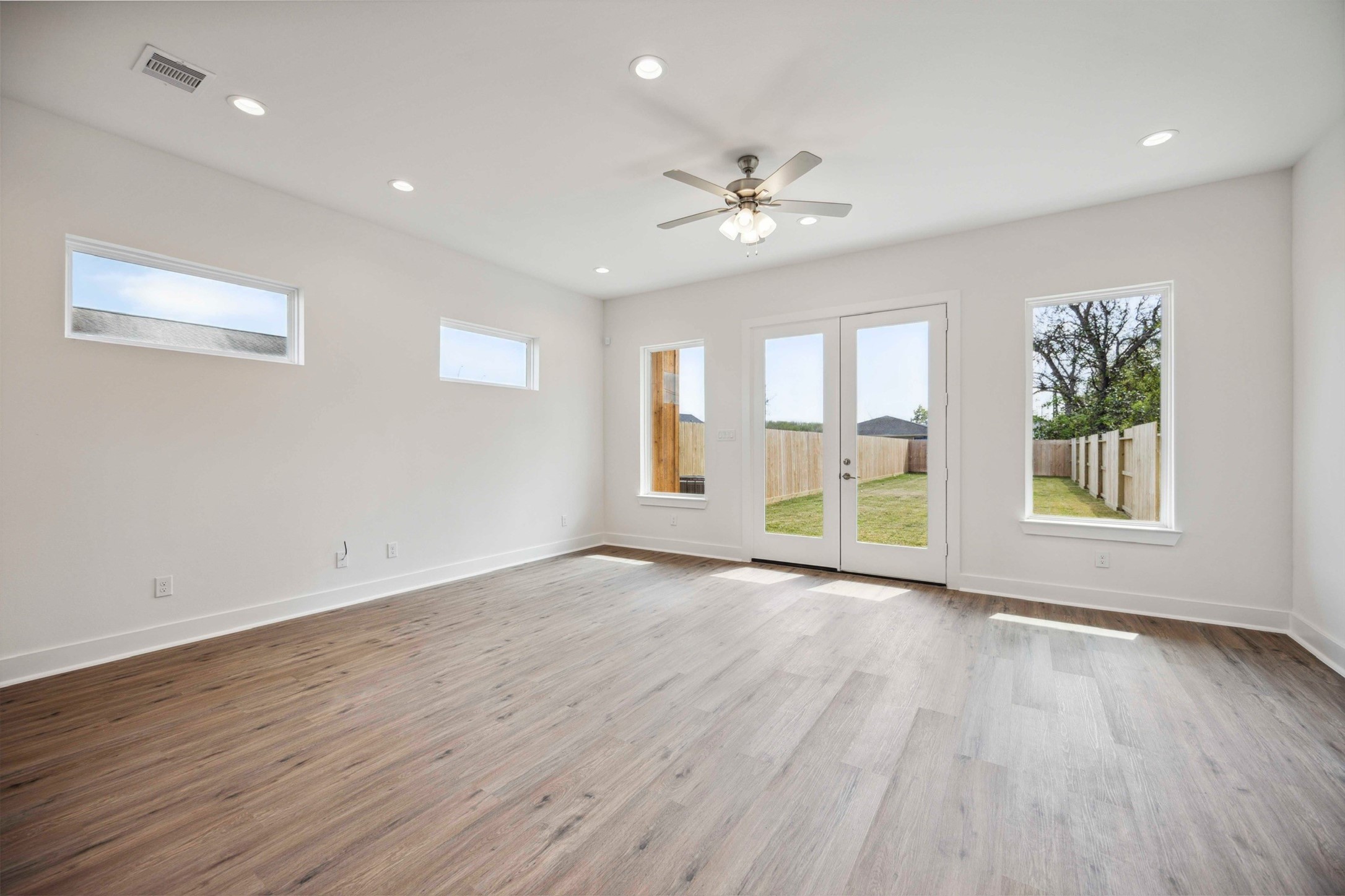 3504 Caplin Street, Unit B Houston, TX 77026 - Photo 5 of 26 a view of an empty room with a window and wooden floor