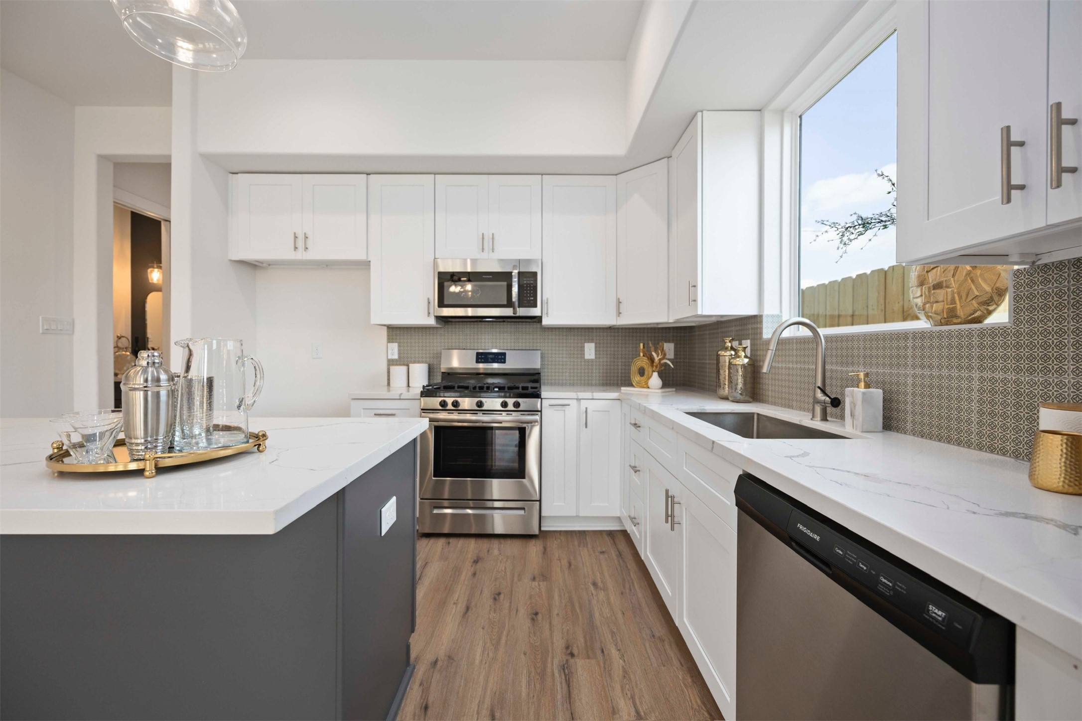 3504 Caplin Street, Unit B Houston, TX 77026 - Photo 6 of 26 a kitchen with kitchen island granite countertop a sink stainless steel appliances and cabinets