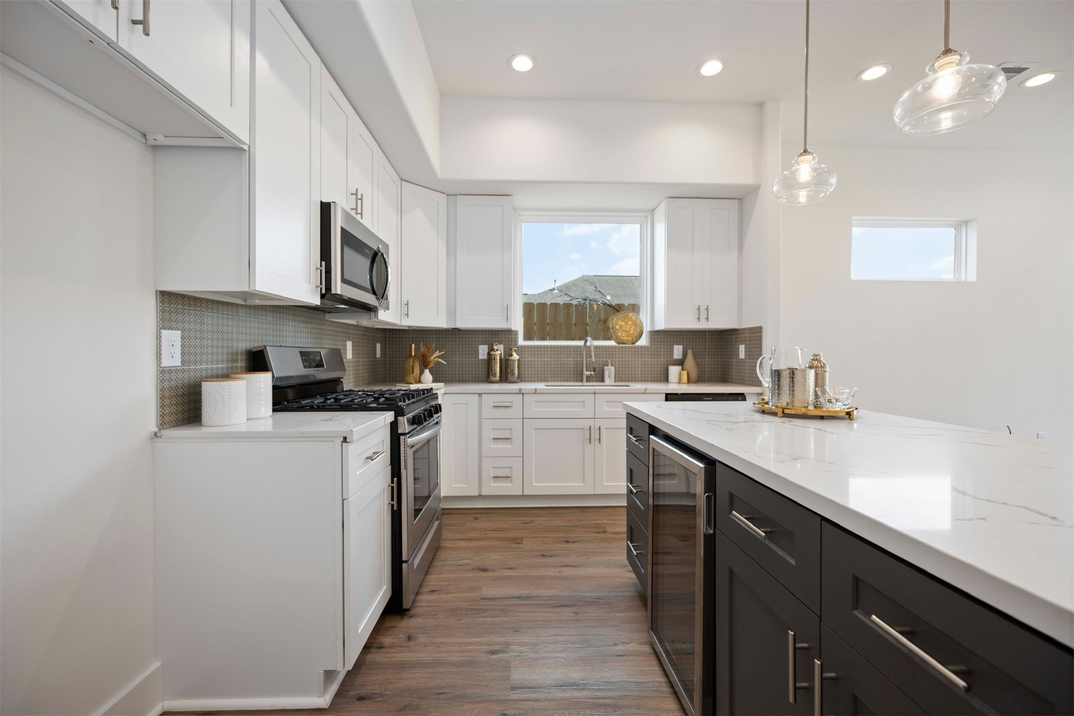 3504 Caplin Street, Unit B Houston, TX 77026 - Photo 7 of 26 a kitchen with cabinets a sink and appliances
