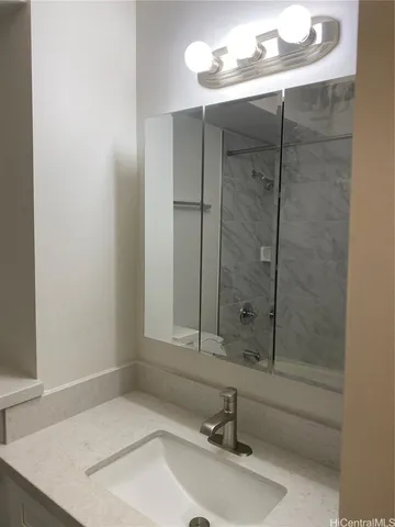 a bathroom with a sink and a mirror
