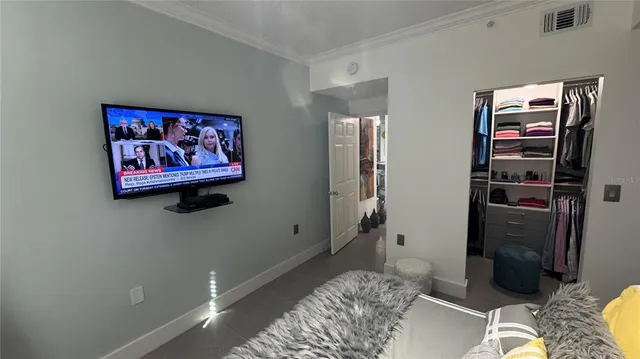a view of walk in closet with clothes and shoes